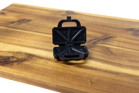 Tiny doll sized sandwich toaster on a wood cutting board Stock Photos