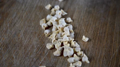 Tiny dumplings with meat on a wooden board. Handmade dumplings Video stock 112990010