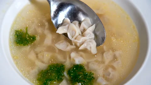 Tiny dumplings in a spoon. Exotic cuisine. Crimean Tatar soup. Asian cuisine Video stock 112989671