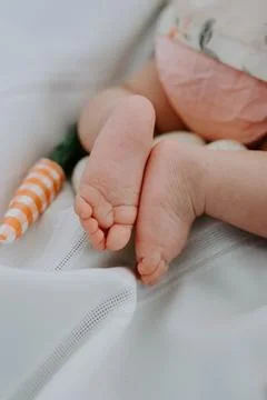 Tiny feet and Easter treats; baby's first holiday delights Stock Photos