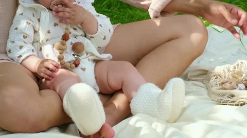 Tiny feet being guided into crocheted shoes. Symbolizes the beginning of a Stock Footage 262628666