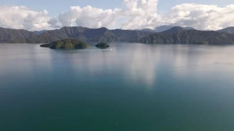 Tiny ferry sailing through the gigantic Marlborough sound. Aerial ascend 動画素材 221038954