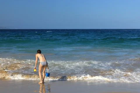 A tiny figure against the mighty waters Stock Photos