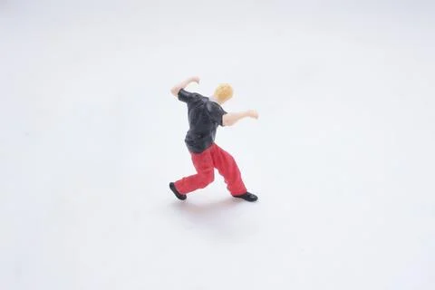 Tiny Figure Doing Handstand Move in White Studio Background Stock Photos