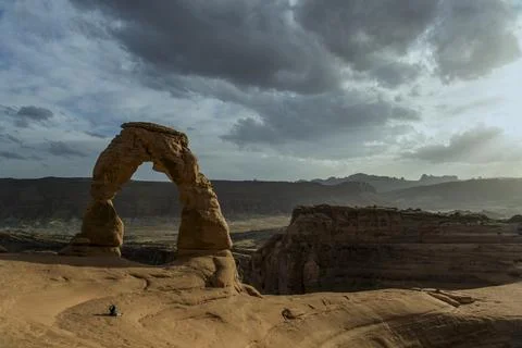 A tiny figure standing in the vast landscape of Arches National Park Stock Photos
