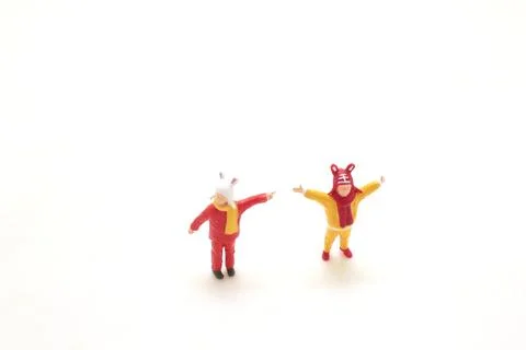 Tiny figures dressed as animals celebrating on white Foto stock