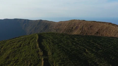 Tiny figures on the top of huge caldera. Green inactive volcano. Aerial of Faial Stock Footage 119599851