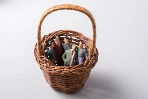 Tiny figurine of group of men miniature model in basket 스톡 일러스트