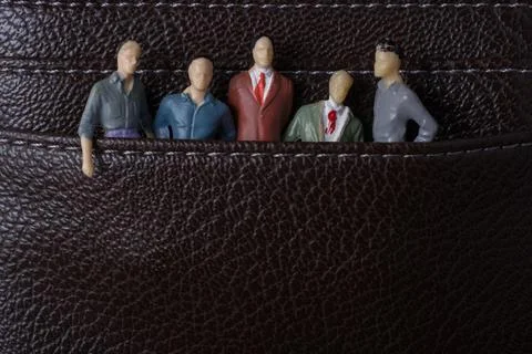 Tiny figurine of group of men miniature model in pockets 스톡 일러스트