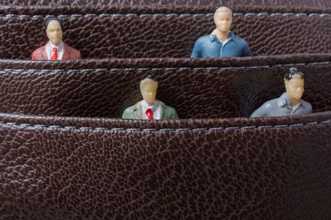 Tiny figurine of group of men miniature model in pockets 스톡 일러스트