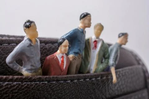 Tiny figurine of group of men miniature model in pockets Stock Illustration