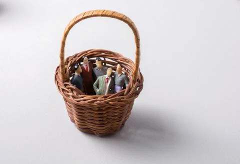 Tiny figurine of group of men miniature model in basket 스톡 일러스트