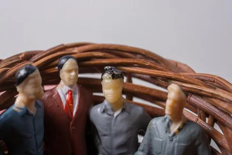 Tiny figurine of group of men miniature model in basket 스톡 일러스트