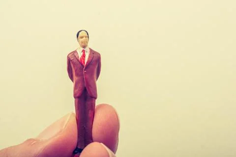 Tiny figurine of man miniature model in hand 写真素材