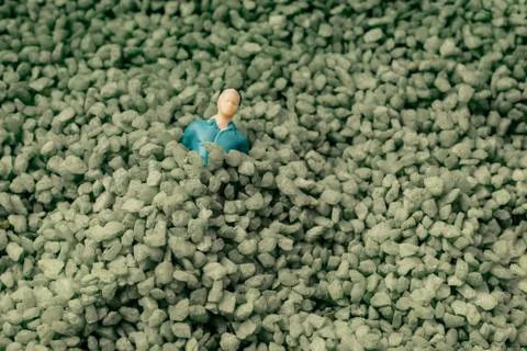 Tiny figurine of man model  in green sand Foto stock