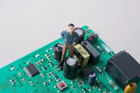 Tiny figurine of men model on Circuit board of electronics 写真素材