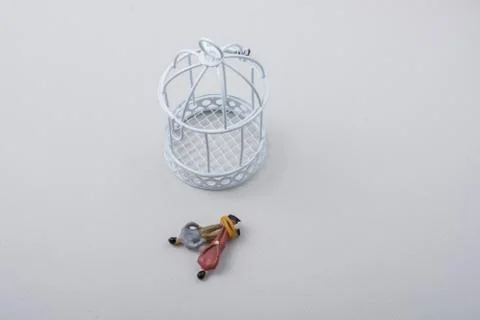 Tiny figurine of men model  tied in rope by cage Stock Photos