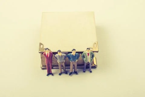 Tiny figurine of men models found beside a book 写真素材