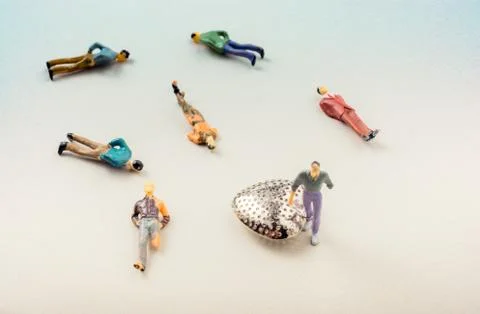 Tiny figurine of men with one  attached to a heart Stock Photos