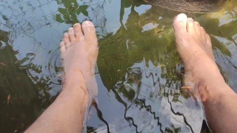 Tiny fish nibble gently on feet in a relaxing Stock Footage 244607839