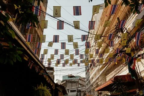 Tiny flags attached to wires above the street, Bangkok, Thailand Foto stock