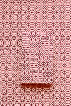 Tiny floral patterned gift on identical background Stock Photos