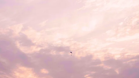 Tiny Flying Paramotor among Pink Color Sky Light Before Sunset Stock Footage 128631861
