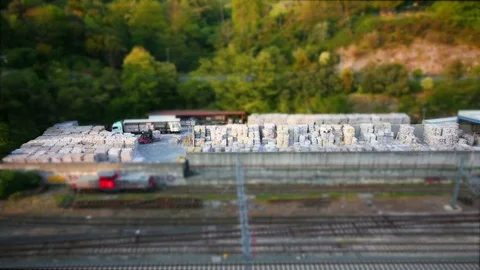 Tiny forklifts unloading paper blocks from lorrys 動画素材 74777058