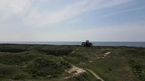 Tiny FPV drone hovers in green nature landscape, Dunes of Schoorl, Stock Footage 255641215
