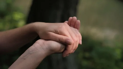 Tiny frog jumps from girls hand Stock Footage 92877491