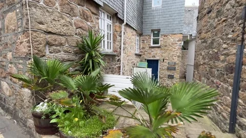 Tiny front garden with pots in England Stock Footage 251298033