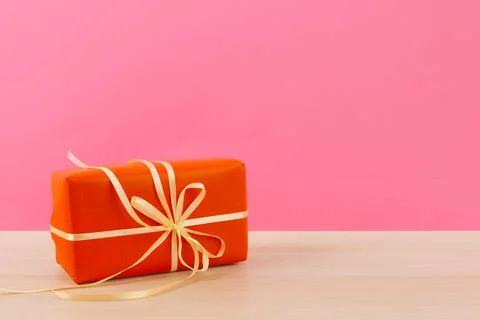 Tiny gift box on pastel pink background Foto stock