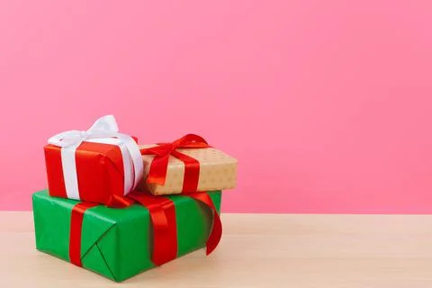 Tiny gift box on pastel pink background Foto stock