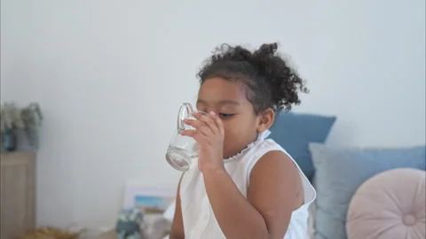 A tiny girl drink milk before bed in the bedroom Video stock 292642734