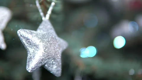 Tiny glitter shining star hanging from a chirstmas tree Stock Footage 147712521