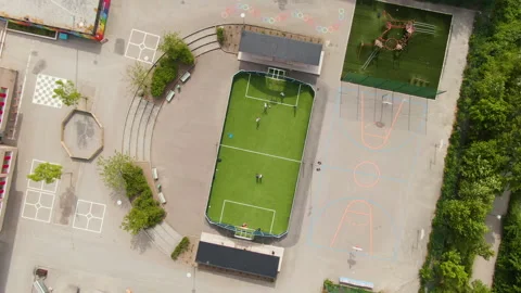 Tiny green football field in school yard in Solna, Stockholm. Aerial top Stock Footage 166954953