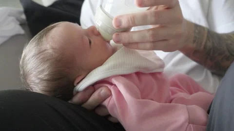 Tiny Hands and Bottle Feeds, Gentle Care for Baby’s Needs Stock Footage 318155661