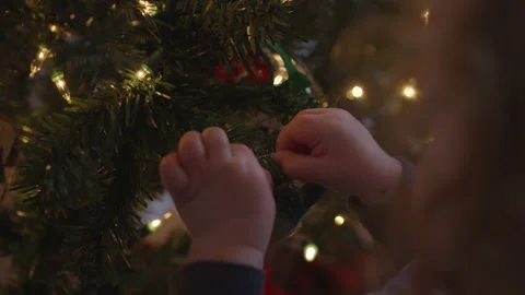 Tiny Hands Hangs an Ornament on a Christmas Tree Stock Footage 208721650
