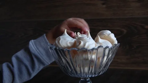 Tiny hands of small kid reaching for piping meringue cookies, close up Stock Footage 117496205