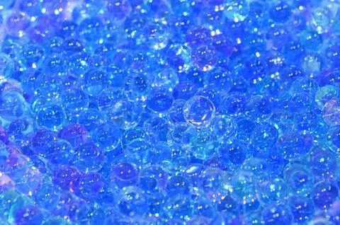 Tiny hard plastic beads balls in blue color background 写真素材