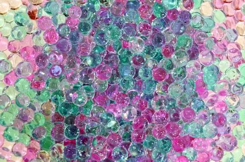 Tiny hard plastic beads balls in pastel colors background Stock Photos