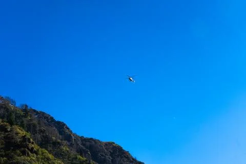 Tiny Helicopter Against an Immense Deep Blue Sky Stock Photos