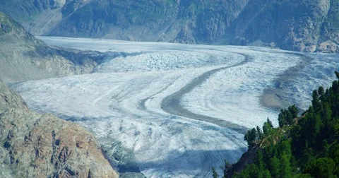 Tiny helicopter passing by Aletsch Glacier - Shot on RED at 5K Stock Footage 79313651