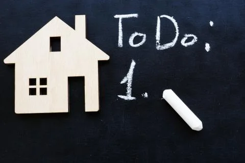Tiny home and to do list for buy property or mortgage. Stock Photos