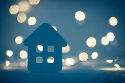 Tiny house on background of christmas lights at night Stock-Fotos