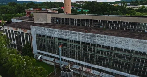 Tiny House Built Among Large Abandoned Communist Era Structures Drone Zoom Out Video stock 300444562