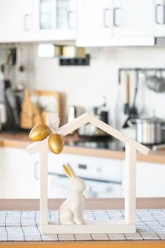 Tiny house of cozy home with Easter decor with rabbit and eggs on table of .. Fotos de archivo