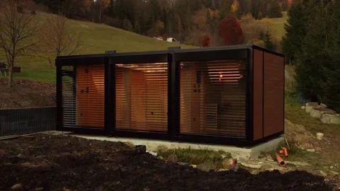 Tiny house transported and being built on site; low angle drone tracking Video stock 237979383