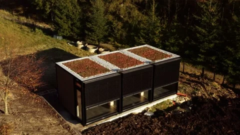 Tiny house transported and being built on site; low angle drone tracking Video stock 237979815
