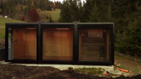 Tiny house transported and being built on site; low angle drone tracking Video stock 237979939